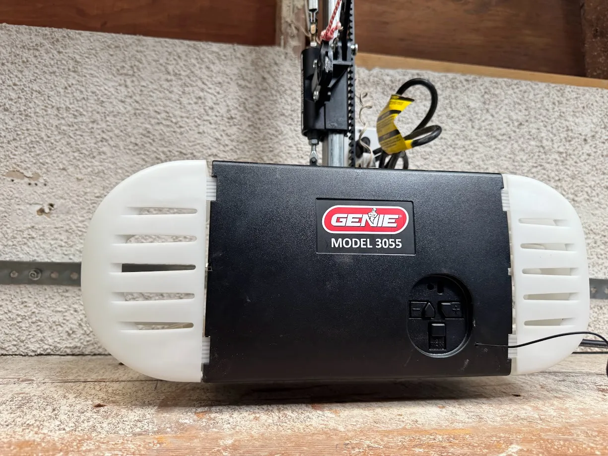 The opener I inherited: a Genie Model 3055 on the rail. A good motor, and completely offline. No app, no WiFi, nothing.